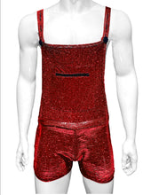 Load image into Gallery viewer, Mannequin wearing red glitter overalls with a zipper kangaroo pouch and buttons to hold the straps. Overalls go down halfway to knees