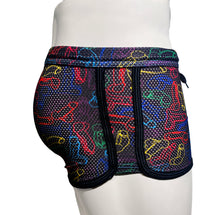 Load image into Gallery viewer, Side view of a mannequin wearing neon rainbow cock print booty shorts, showing the side trim
