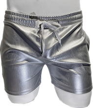 Load image into Gallery viewer, Mannequin wearing silver faux leather shorts with side pockets and a white string waistband