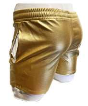 Load image into Gallery viewer, Side rear view of gold faux leather shorts with side pockets and a white string waistband