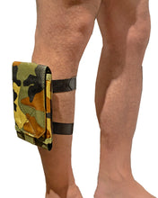 Load image into Gallery viewer, Close up view camo canvas arm/leg bag worn on the leg, flap down