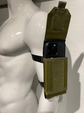 Load image into Gallery viewer, Army green canvas arm bag worn on the arm of a mannequin, with a phone in the pocket