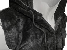 Load image into Gallery viewer, Close up view of the zipper on a black sleeveless faux fur hoodie