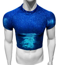 Load image into Gallery viewer, A mannequin wearing a short-sleeved, blue crop top with turquoise undertones and glitter throughout.