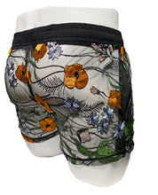 Load image into Gallery viewer, A pair of black and orange floral mesh shorts with side pockets and a drawstring waistband displayed on a mannequin - rear view
