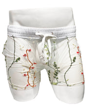 Load image into Gallery viewer, White mesh shorts with red embroidered floral patterns, featuring side pockets and a drawstring.