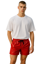 Load image into Gallery viewer, Man wearing a white t-shirt and bright red shorts on a white background
