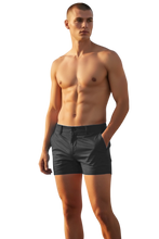 Load image into Gallery viewer, Black chino shorts worn by a shirtless model