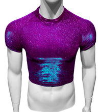 Load image into Gallery viewer, A mannequin wearing a short-sleeved, crop-length t-shirt in magenta with blue/cyan glitter undertones.