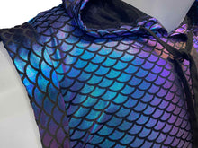 Load image into Gallery viewer, Close up of neckline of mannequin wearing a blue and purple metallic hooded crop top with mermaid scale print pattern