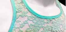Load image into Gallery viewer, Close up of neckline of mannequin wearing a floral lace tank top in aqua blue green.