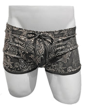 Load image into Gallery viewer, Black swim trunks with silver metallic floral print and black drawstring on a white mannequin
