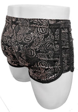 Load image into Gallery viewer, Black swim trunks with silver metallic floral print and black drawstring on a white mannequin, rear view

