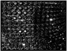 Load image into Gallery viewer, Close-up of a textured black surface with circular patterns
