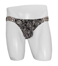 Load image into Gallery viewer, Black and Silver paisley print swim brief with silver chain embellishments on the waistband, displayed on a white mannequin.
