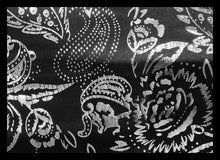 Load image into Gallery viewer, Black and silver fabric featuring a detailed paisley and floral pattern, shown in a close-up view with a subtle sheen.
