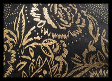Load image into Gallery viewer, A close-up of a black textured fabric with an ornate gold floral and paisley pattern.
