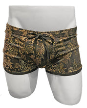 Load image into Gallery viewer, Black swim trunks with gold floral metallic print and black drawstring waistband, on a white mannequin
