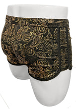 Load image into Gallery viewer, Black swim trunks with gold floral metallic print and black drawstring waistband, on a white mannequin - rear view

