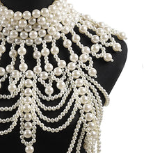 Load image into Gallery viewer, Necklace with multiple strands of pearls draped over a black mannequin.
