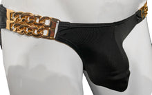 Load image into Gallery viewer, Close up of black swim underwear showing gold chains at the sides that hold the fabric 

