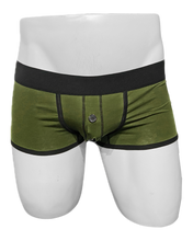 Load image into Gallery viewer, Army green cotton trunks with black waistband on a mannequin, featuring black trim and a button closed fly
