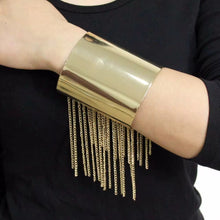 Load image into Gallery viewer, Gold fringed cuff bracelet on a person's wrist 
