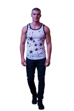 Load image into Gallery viewer, Model wearing a white mesh tank top with printed black stars and black trim
