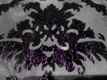 Load image into Gallery viewer, Close-up of a black damask velvet fabric with purple metallic embroidery over a sheer black mesh 
