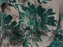 Load image into Gallery viewer, Close up view of black mesh fabric with teal flocked floral embellishments.
