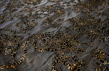 Load image into Gallery viewer, Close up detail view of black mesh fabric with black and gold velvet embellishments
