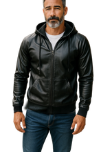 Load image into Gallery viewer, Man wearing a black zip-up faux leather hoodie with black zipper and hood strings
