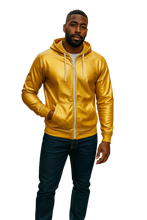 Load image into Gallery viewer, Man wearing a gold zip-up faux leather hoodie with white zipper and hood strings. 
