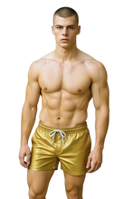 Load image into Gallery viewer, Man wearing gold faux leather shorts with side pockets and a white string waistband
