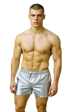 Load image into Gallery viewer, Man wearing silver faux leather shorts with side pockets and a white string waistband
