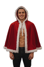 Load image into Gallery viewer, Man wearing a red velvet cape with white fur trim 
