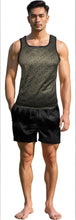 Load image into Gallery viewer, Man wearing an army green tank top and black shorts. Tank as diagonal "Slut" text printed all over it.
