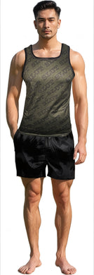 Man wearing an army green tank top and black shorts. Tank as diagonal 