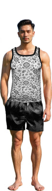 Man wearing a patterned white tank top and black shorts on a white background