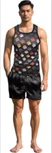 Load image into Gallery viewer, Man wearing a black tank top and black shorts.  The black tank top has a colorful bear paw print pattern.
