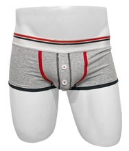 Load image into Gallery viewer, Light grey cotton trunks with a button fly, displayed on a mannequin. Features red and black trim
