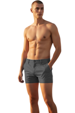 Load image into Gallery viewer, Dark grey chino shorts worn by a shirtless model
