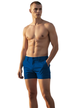 Load image into Gallery viewer, Navy chino shorts worn by a shirtless model
