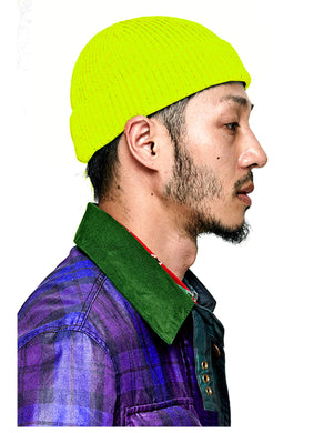 Side view of man wearing neon yellow fisherman's beanie