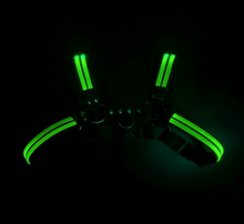 Load image into Gallery viewer, Black harness with glowing green light strips on a dark background
