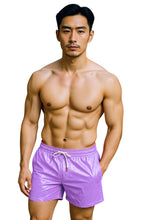 Load image into Gallery viewer, Man wearing lavender swim shorts on a white background
