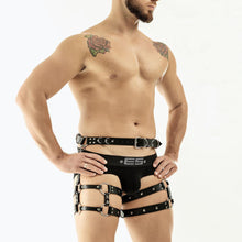 Load image into Gallery viewer, Man wearing a black leg harness with black underwear on a white background
