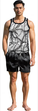 Man wearing a white and black chain-patterned tank top and black shorts 