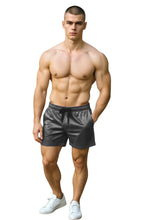 Load image into Gallery viewer, Man wearing gray velvet shorts with pockets and a drawstring
