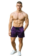 Load image into Gallery viewer, Man wearing purple velvet shorts with pockets and a drawstring
